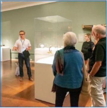 visitors to a museum listening to a tour guide